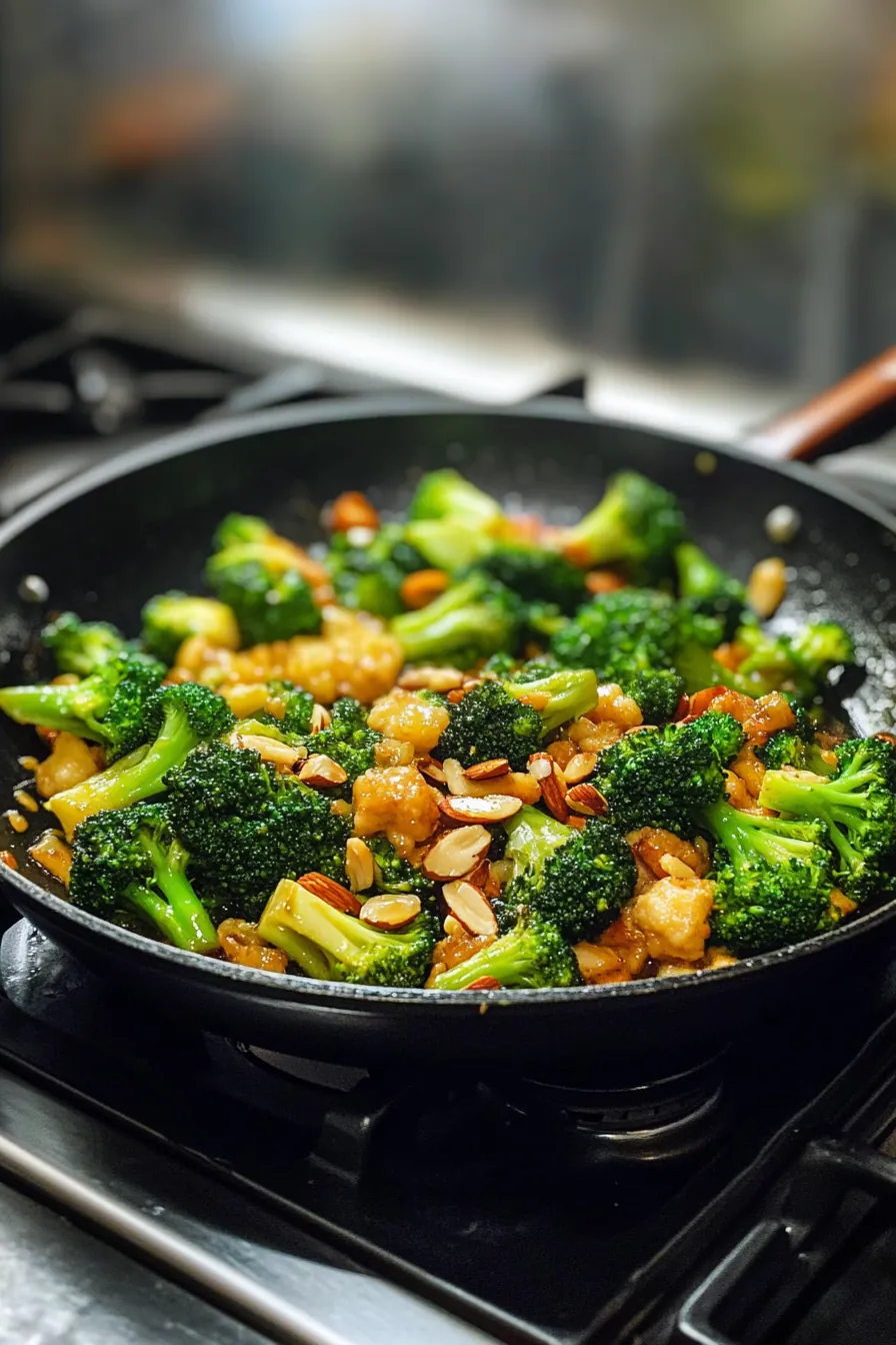 Vibrant green broccoli stir-fry with toasted almonds in a white dish