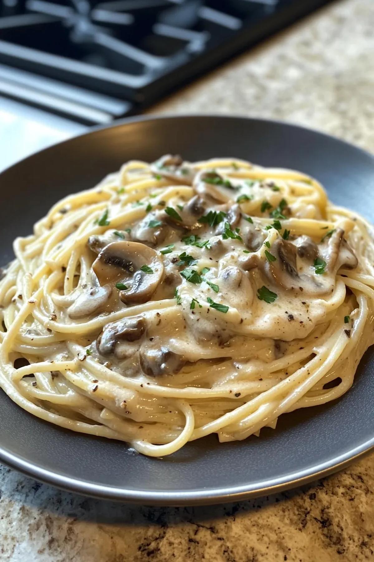 Creamy garlic mushroom pasta served in a rustic bowl, garnished with fresh parsley and parmesan, showcasing a rich creamy pasta pan sauce.