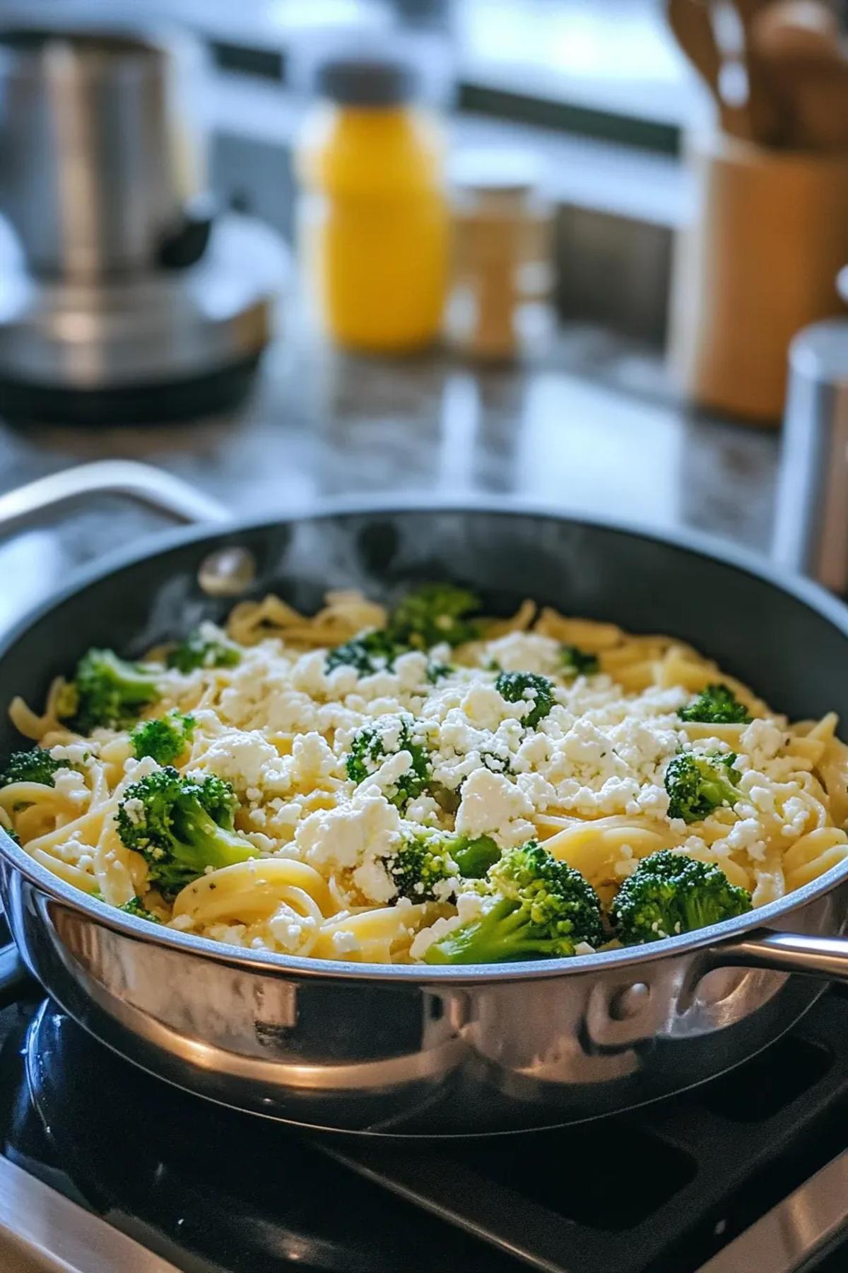 A vibrant bowl of one pot pasta broccoli feta, featuring al dente pasta, bright green broccoli florets, and crumbled feta cheese, garnished with fresh herbs. card
