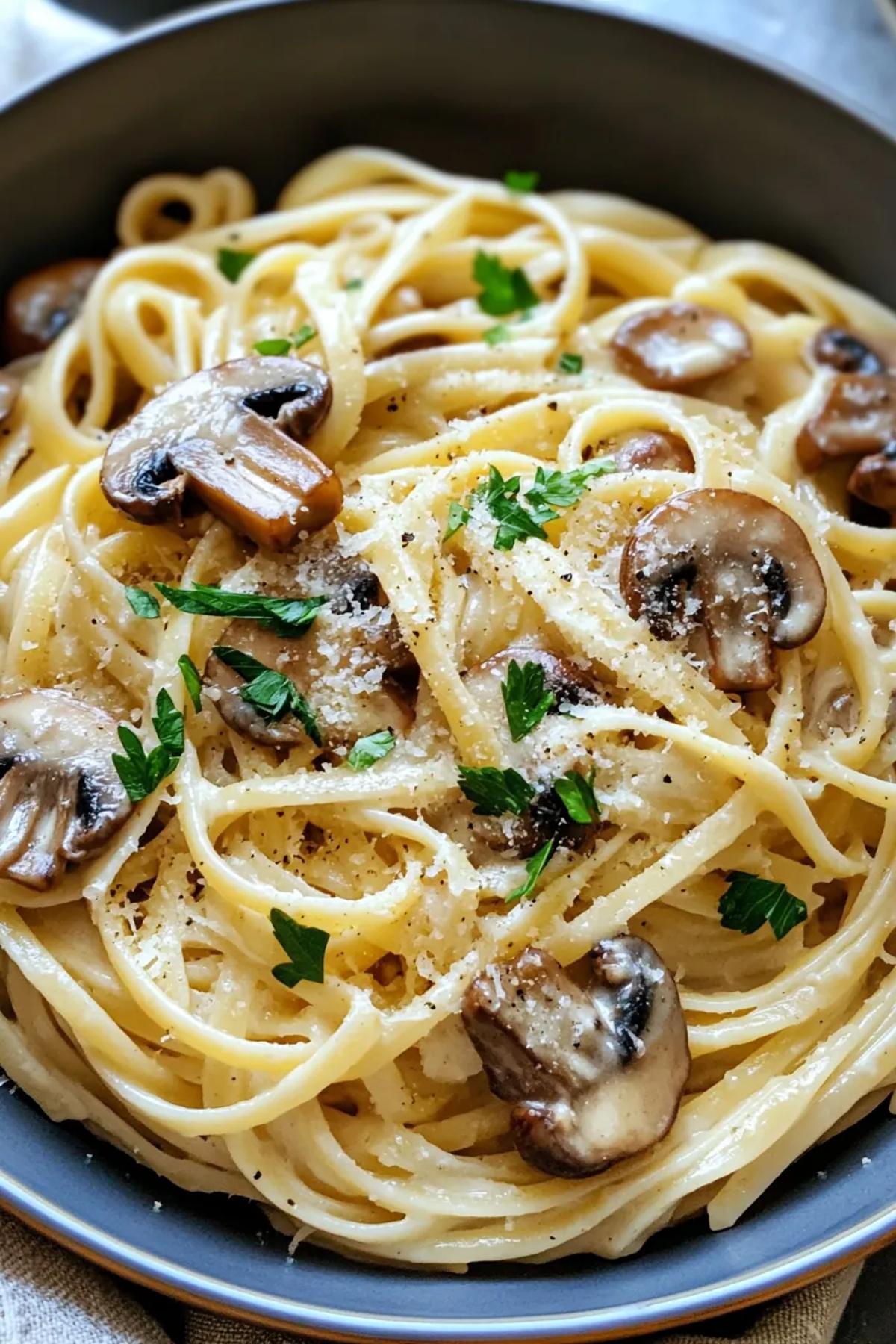 A delicious bowl of one pot mushroom pasta no cream, featuring al dente pasta intertwined with sautéed mushrooms, fresh herbs, and a sprinkle of parmesan, served in a rustic bowl. card