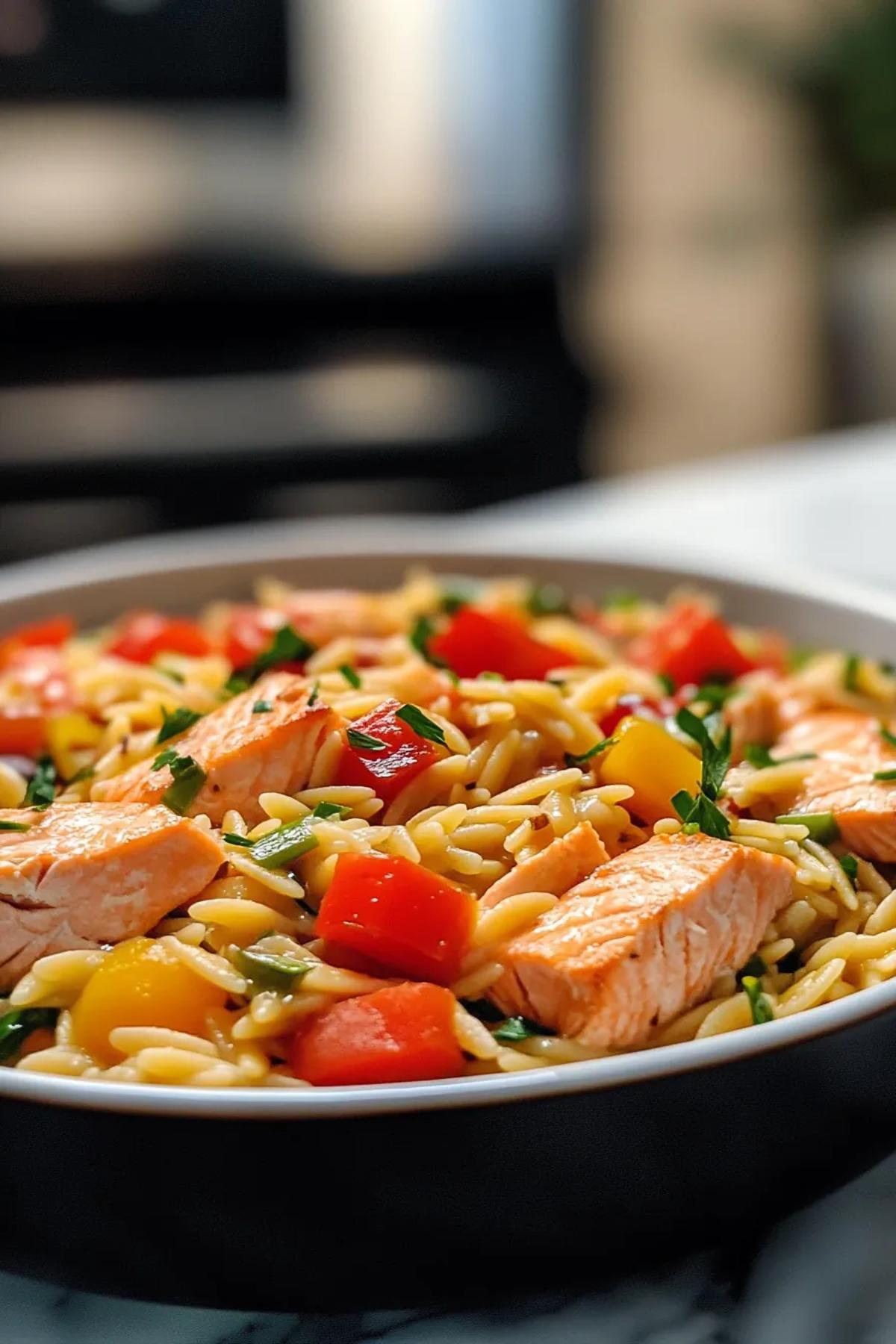 One pot salmon orzo with bright seasonal vegetables in a rustic ceramic skillet. card