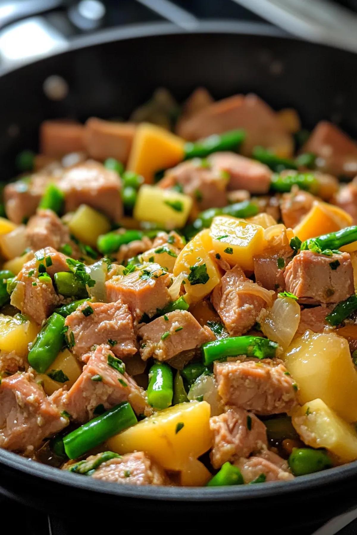 A colorful one pot tuna dish with peas, carrots, and pasta in a creamy sauce. card